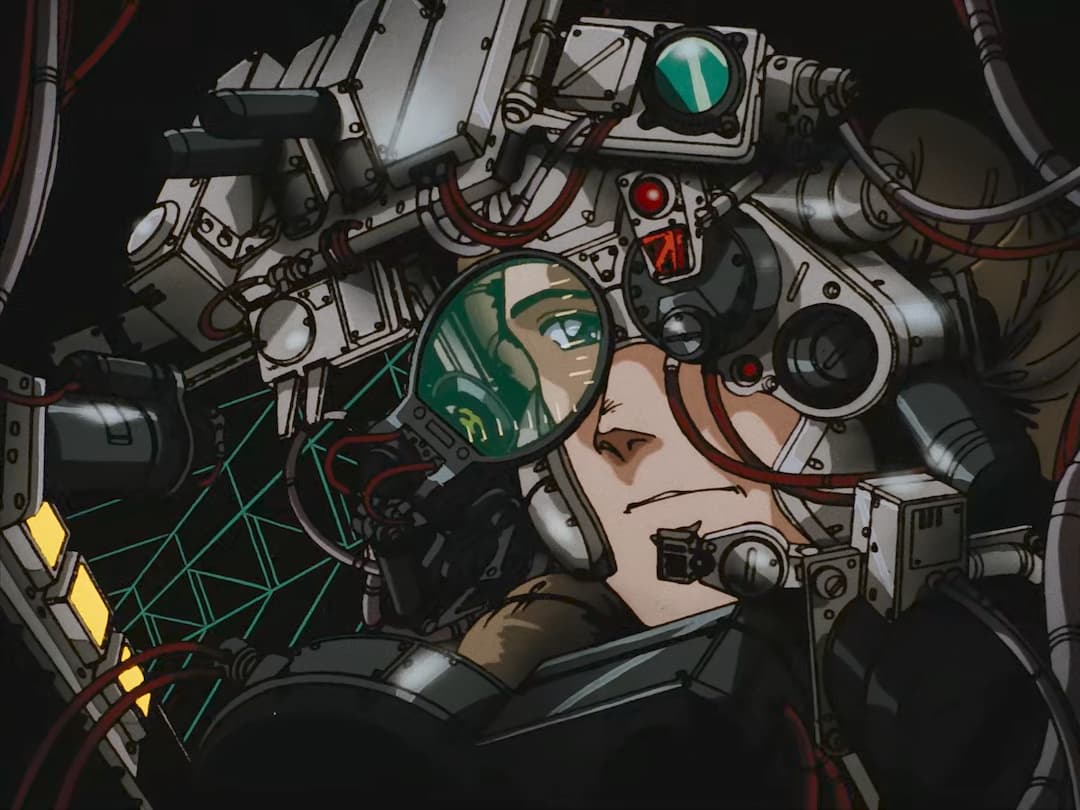A close-up illustration shows a person's face surrounded by complex mechanical and electronic components. A magnifying lens focuses on the person's green eye. The machinery appears to be attached to the person's head and face, with wires and metal parts visible. The overall aesthetic is reminiscent of 80's cyberpunk anime or science fiction themes.
